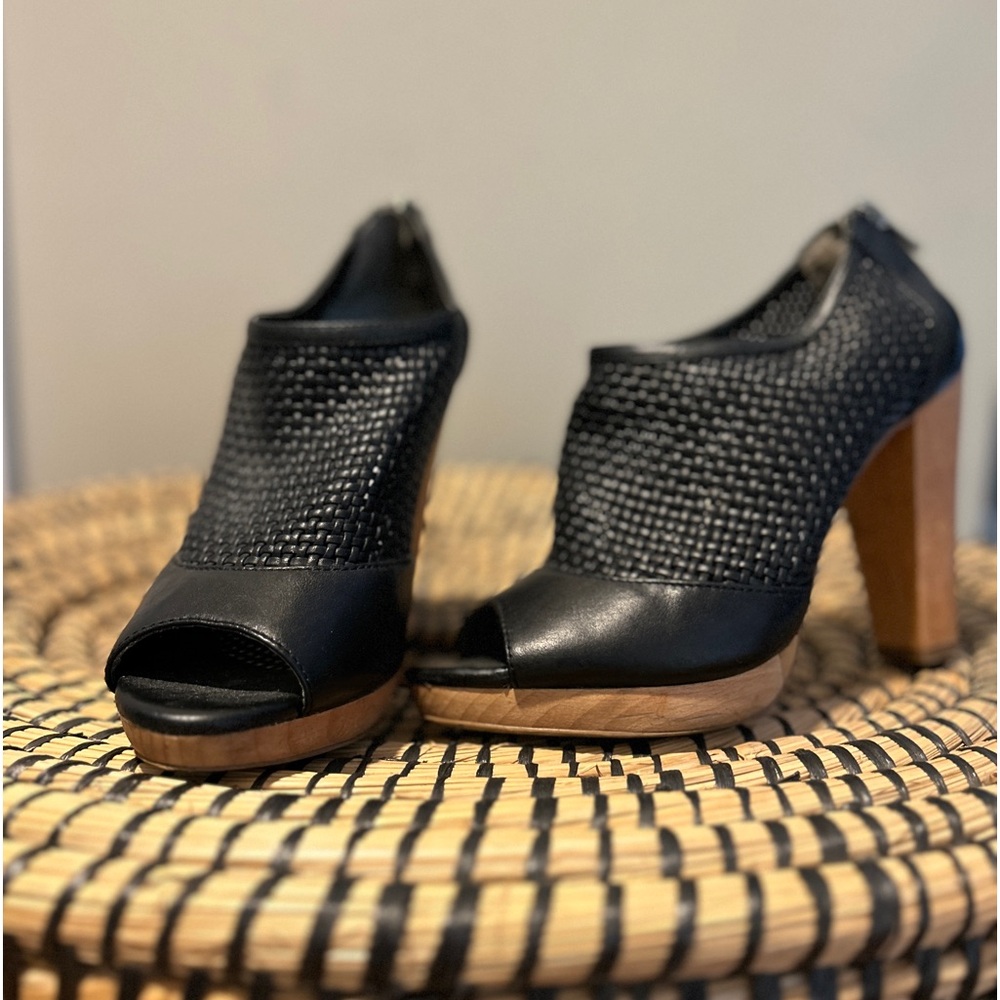 Black leather platform booties with peep toe.
